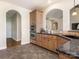 Kitchen featuring wooden cabinets, granite countertops, stainless appliances, and tile backsplash at 16160 Hopewell Church Rd, Midland, NC 28107