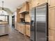 Well-equipped kitchen features stainless steel appliances, wooden cabinetry and stylish tile flooring at 16160 Hopewell Church Rd, Midland, NC 28107
