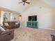 Bright living room with plush carpeting, vaulted ceiling, and a modern entertainment center at 16160 Hopewell Church Rd, Midland, NC 28107