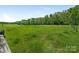 Open green pasture with a wooden fence, perfect for horses or livestock at 16160 Hopewell Church Rd, Midland, NC 28107