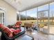 Inviting screened porch with outdoor seating and a peaceful view of the property at 16160 Hopewell Church Rd, Midland, NC 28107