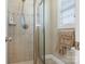 Bathroom shower featuring tile walls and a glass door, with a window providing natural light at 16160 Hopewell Church Rd, Midland, NC 28107