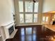 Bright living room featuring a fireplace, built-in shelving, high ceilings, and large windows for natural light at 16446 Doves Canyon Ln, Charlotte, NC 28278