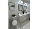All-white bathroom with double sinks, framed mirrors, and decorative plants provides a clean and bright space at 1713 Archdale Dr, Charlotte, NC 28210