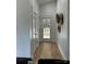 Bright hallway features a door leading outside and rustic decorative wall baskets at 1713 Archdale Dr, Charlotte, NC 28210