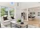 Light filled living room showcasing vaulted ceilings, large windows, and an open floor plan to kitchen at 1713 Archdale Dr, Charlotte, NC 28210