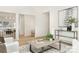 Open-concept living room with hardwood floors and views to the kitchen and dining spaces at 1713 Archdale Dr, Charlotte, NC 28210