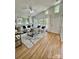 Bright living room with vaulted ceilings, large windows, and hardwood flooring and neutral colors at 1713 Archdale Dr, Charlotte, NC 28210