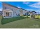 View of a spacious backyard featuring a play set, grill, and well-manicured lawn, perfect for outdoor enjoyment at 187 Tetcott St, Mooresville, NC 28115