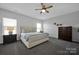 Comfortable bedroom featuring a stylish bed, modern ceiling fan, and dresser at 187 Tetcott St, Mooresville, NC 28115