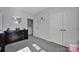 Well-lit bedroom featuring a dark wood dresser, gray carpet, and a stylish circular mirror at 187 Tetcott St, Mooresville, NC 28115