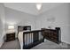Charming bedroom featuring a dark wood bed frame, a chandelier, and neutral walls at 187 Tetcott St, Mooresville, NC 28115