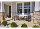 Cozy covered front porch with rocking chairs and stone pillars, a welcoming outdoor space at 187 Tetcott St, Mooresville, NC 28115