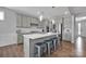 Modern kitchen with grey cabinets, stainless steel appliances, a large island, and pendant lighting at 187 Tetcott St, Mooresville, NC 28115