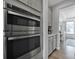 Modern kitchen featuring built-in stainless steel microwave and oven, with grey cabinetry at 187 Tetcott St, Mooresville, NC 28115