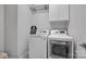 Convenient laundry room with a front loading washer and dryer with overhead storage at 187 Tetcott St, Mooresville, NC 28115