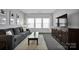 Comfortable living room with a neutral sofa, large TV, and contemporary decor at 187 Tetcott St, Mooresville, NC 28115