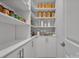 Walk-in pantry with ample shelving and cabinet space for organized storage at 187 Tetcott St, Mooresville, NC 28115