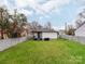 Spacious backyard featuring a well-maintained lawn, a privacy fence, and mature trees, perfect for outdoor living at 1916 Pegram St, Charlotte, NC 28205