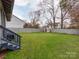 Expansive backyard featuring lush green grass, privacy fence, and access to the home via steps from a deck at 1916 Pegram St, Charlotte, NC 28205