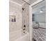 Bright bathroom offers a soaking tub with modern fixtures and a glimpse into an adjacent Bedroom room at 1916 Pegram St, Charlotte, NC 28205