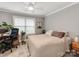 Bright and comfortable bedroom with a ceiling fan, a window, and a dedicated desk area at 1916 Pegram St, Charlotte, NC 28205
