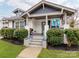 Charming bungalow-style home featuring a covered front porch, painted brick, and professionally landscaped front yard at 1916 Pegram St, Charlotte, NC 28205