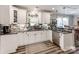 Bright kitchen featuring white cabinets, stainless steel appliances, dark countertops, and a modern backsplash at 1916 Pegram St, Charlotte, NC 28205