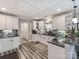 Bright kitchen featuring white cabinets, dark countertops, modern appliances, and sleek, gray flooring at 1916 Pegram St, Charlotte, NC 28205