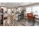 Eat-in kitchen featuring gray floors, bar seating, a breakfast table, and white cabinets with dark countertops at 1916 Pegram St, Charlotte, NC 28205