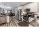 Open kitchen featuring modern stainless steel appliances, white cabinets, and dark backsplash at 1916 Pegram St, Charlotte, NC 28205