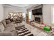 Open-concept living room featuring a modern fireplace, plush gray sectional, and sleek, gray flooring at 1916 Pegram St, Charlotte, NC 28205