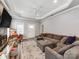 Spacious living room featuring tray ceilings, a ceiling fan, plush sectional, and neutral decor at 1916 Pegram St, Charlotte, NC 28205