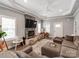 Large living area featuring an elegant fireplace, tray ceilings, a neutral color palette, and a comfortable sectional at 1916 Pegram St, Charlotte, NC 28205
