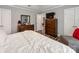 Well-lit main bedroom with a dresser, television, soft carpet, and neutral tones, creating a cozy atmosphere at 1916 Pegram St, Charlotte, NC 28205