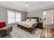 Relaxing main bedroom boasts a ceiling fan, ample natural light, and a comfortable seating area at 1916 Pegram St, Charlotte, NC 28205