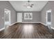 Open living room with hardwood floors, neutral paint, and multiple doorways at 1980 Stirewalt Rd, China Grove, NC 28023