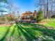 Beautiful backyard with a patio, landscaped retaining wall and a serene creek running through it at 2217 Blue Bell Ln, Charlotte, NC 28270