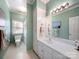 Bright bathroom with a white vanity, large mirror, and a shower-tub combo at 2217 Blue Bell Ln, Charlotte, NC 28270