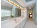 Bright bathroom with a large mirror, double sinks, and bathtub, perfect for relaxation after a long day at 2217 Blue Bell Ln, Charlotte, NC 28270