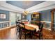 Elegant dining room featuring a wooden table, chandelier, and built-in hutch at 2217 Blue Bell Ln, Charlotte, NC 28270