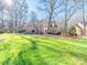Charming brick home with lush green lawn and mature trees in a well-maintained front yard at 2217 Blue Bell Ln, Charlotte, NC 28270