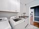 Bright laundry room features white cabinets, granite countertop, and modern washer and dryer at 2217 Blue Bell Ln, Charlotte, NC 28270