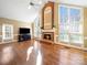 Spacious living room featuring a brick fireplace, vaulted ceilings, and large windows at 2217 Blue Bell Ln, Charlotte, NC 28270