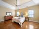 Inviting main bedroom with tray ceilings, hardwood floors, two windows, a dresser, and two nightstands for relaxing at 2217 Blue Bell Ln, Charlotte, NC 28270