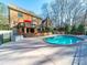 Backyard oasis featuring a refreshing pool, a brick home, and an upper level deck, perfect for outdoor relaxation at 2217 Blue Bell Ln, Charlotte, NC 28270