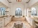 Bathroom with double vanities, an arched window with stained glass, and a soaking tub at 235 Blue River Rd, Clover, SC 29710