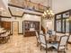 Open-concept dining room with custom built-ins, a decorative chandelier, and a view of the upper-level balcony at 235 Blue River Rd, Clover, SC 29710