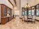 Elegant dining room featuring custom cabinetry, chandelier, and a bay window with views of the outdoor landscape at 235 Blue River Rd, Clover, SC 29710