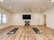 Large exercise room with wood flooring, a ceiling fan, bright windows, and wall-mounted television at 235 Blue River Rd, Clover, SC 29710